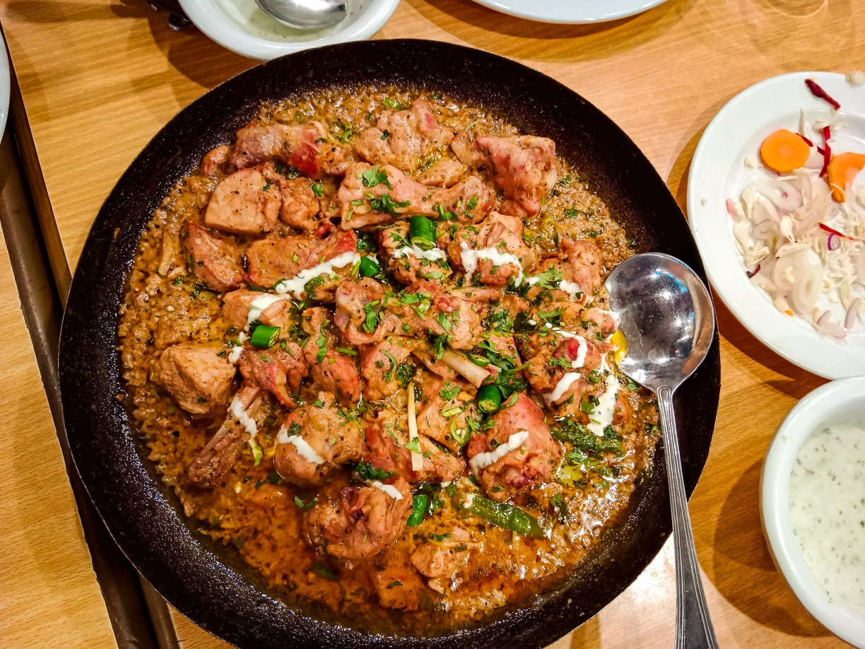 Desi butter chiken masala serverd in karahi top view of indian, pakistani karai food